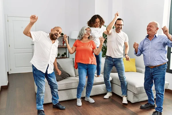 Group of middle age friends having party dancing at home.