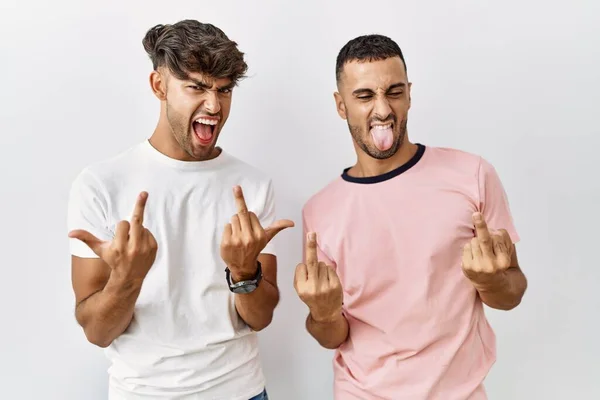 Young Gay Couple Standing Isolated Background Showing Middle Finger Doing — Stock Fotó