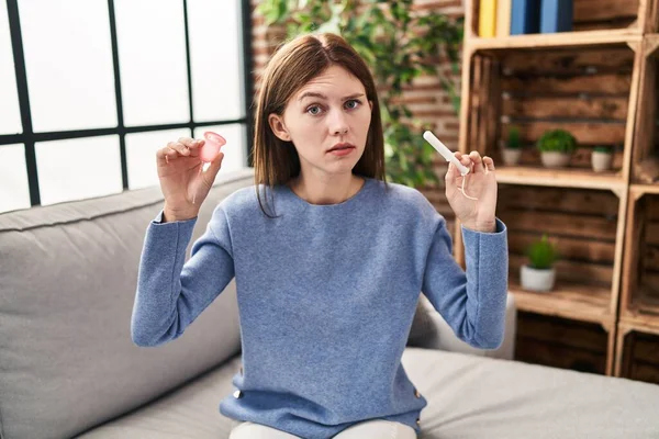 Young Brunette Woman Holding Menstrual Cup Tampon Skeptic Nervous Frowning — 스톡 사진