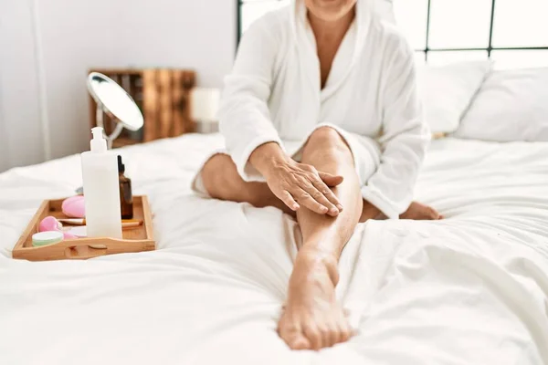Woman Caring Skin Legs Using Hydration Cream Sitting Bed Bedroom — Stockfoto