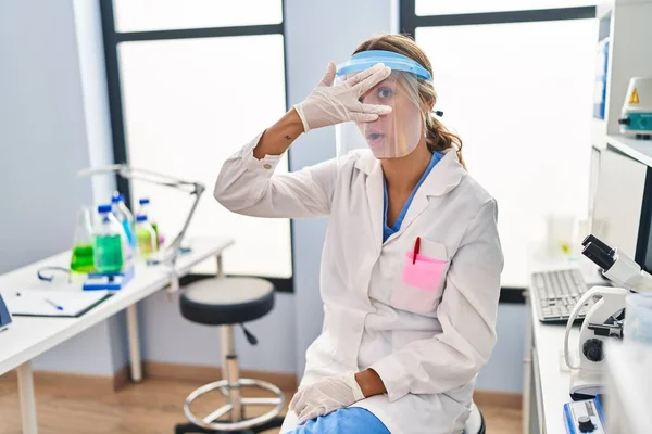 Young Blonde Woman Working Scientist Laboratory Wearing Face Mask Peeking — Stockfoto