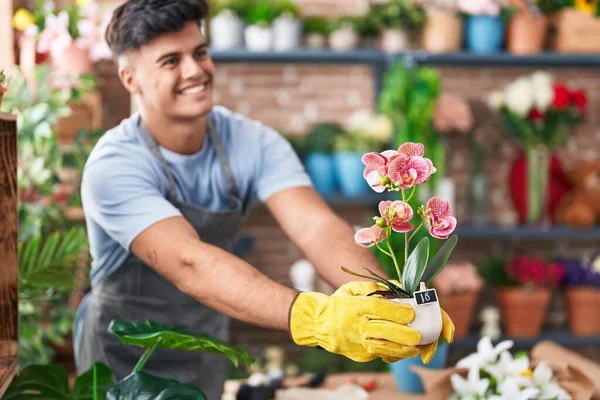 Jonge Spaanse Man Bloemist Glimlachend Zelfverzekerde Holding Plant Bloemenwinkel — Stockfoto