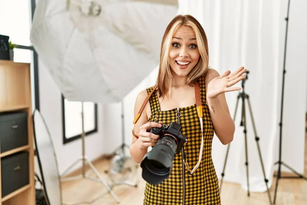 Young Caucasian Photographer Girl Holding Professional Camera Photography Studio Celebrating — Stockfoto