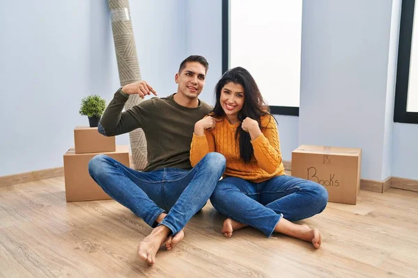 Young Couple Sitting Floor New Home Looking Confident Smile Face — Stock Photo, Image