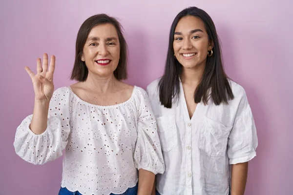 Hispanic Mother Daughter Together Showing Pointing Fingers Number Four While — Stock Photo, Image
