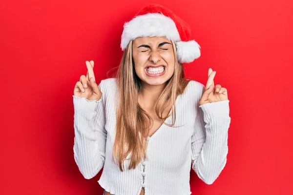 Mulher Hispânica Bonita Vestindo Chapéu Natal Gesto Dedo Cruzado Sorrindo — Fotografia de Stock