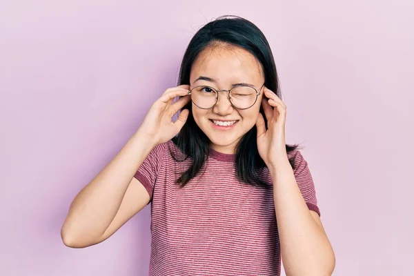 Young Chinese Girl Wearing Casual Clothes Glasses Covering Ears Fingers — Stok fotoğraf