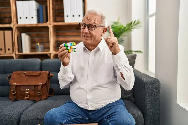 Senior Therapist Grey Hair Playing Colorful Puzzle Cube Intelligence Game — ストック写真
