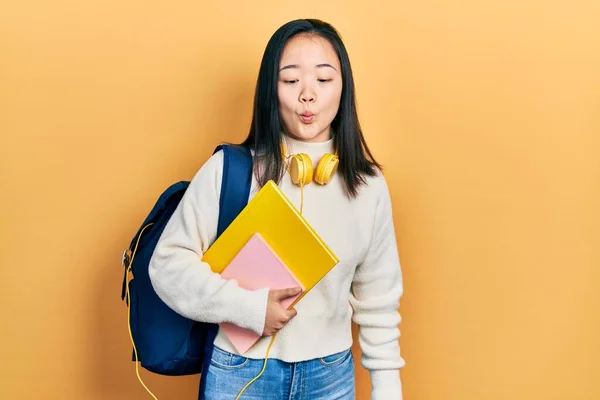 Young Chinese Girl Holding Student Backpack Books Making Fish Face — Fotografia de Stock