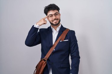 Hispanic man with beard wearing business clothes smiling pointing to head with one finger, great idea or thought, good memory 