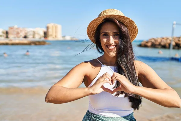 Young Hispanic Woman Smiling Confident Doing Heart Gesture Hands Seaside — Stock Photo, Image