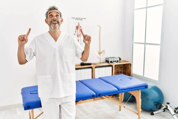 Der Hispanische Therapeut Mittleren Alters Der Der Schmerzklinik Arbeitet Lächelt — Stockfoto