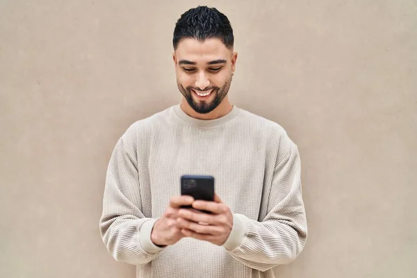 아라파 청년은 스마트폰을 사용하여 자신있게 웃는다 — 스톡 사진