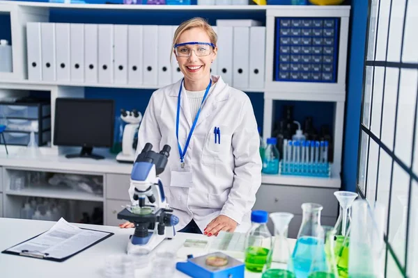 Young Blonde Woman Scientist Smiling Confident Using Microscope Laboratory — Stock Photo, Image