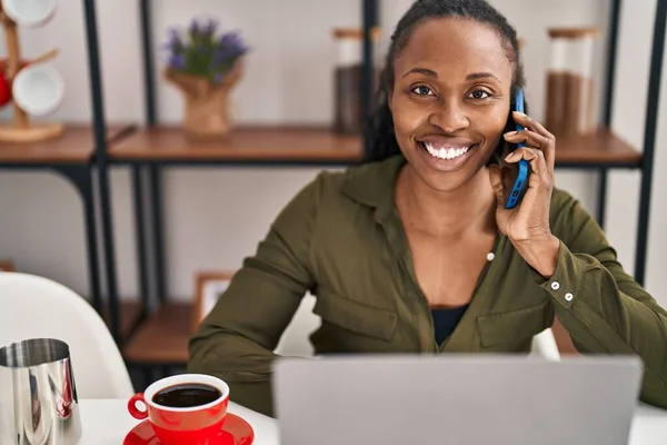 African American Woman Using Laptop Talking Smartphone Home — Stock Photo, Image