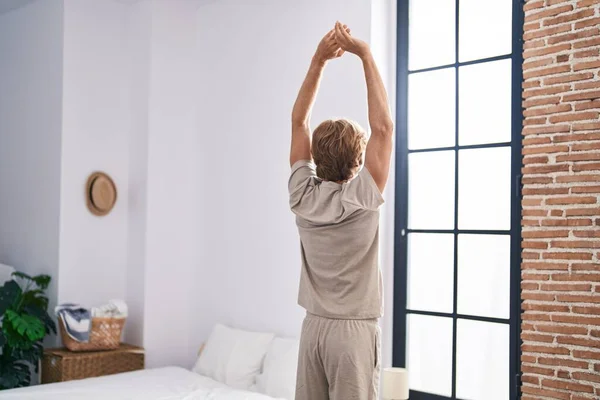 Young Man Waking Stretching Arms Bedroom — Stockfoto