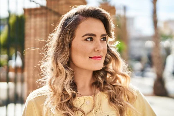 Young woman smiling confident looking to the side at street