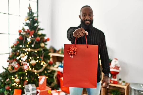 Young African American Man Holding Bag Gift Standing Christmas Tree —  Fotos de Stock