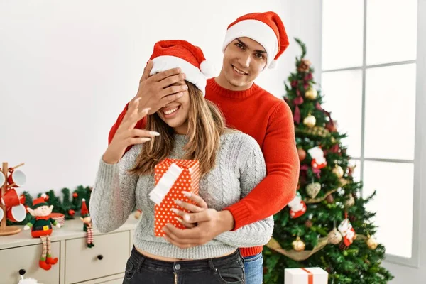 Young Couple Hugging Smiling Happy Man Surprising Woman Gift Home — Stock Photo, Image