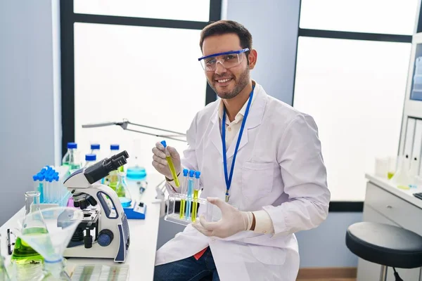 Young Hispanic Man Scientist Holding Test Tubes Laboratory —  Fotos de Stock