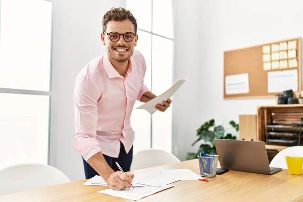 Junger Hispanischer Mann Lächelt Selbstbewusst Und Schreibt Büro Auf Ein — Stockfoto