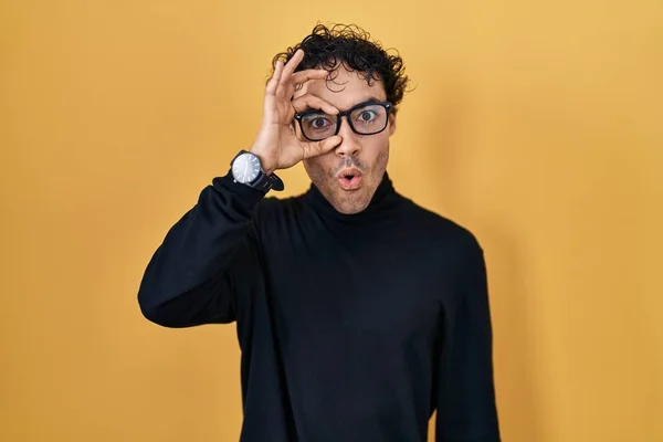 Hispanic Man Standing Yellow Background Doing Gesture Shocked Surprised Face — 스톡 사진