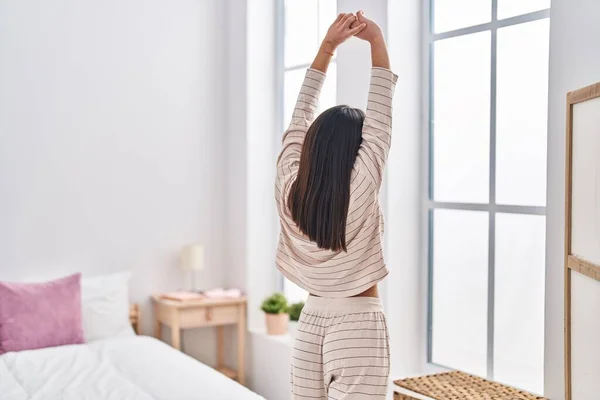 Young Hispanic Woman Stretching Arms Standing Bedroom — Fotografia de Stock