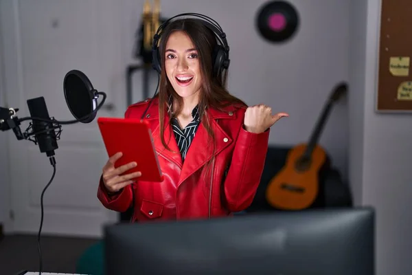 Młoda Brunetka Śpiewa Piosenkę Pomocą Mikrofonu Wskazując Kciuk Góry Bok — Zdjęcie stockowe