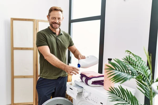 Middle Age Hispanic Man Smiling Confident Using Detergent Laundry Room — Stockfoto