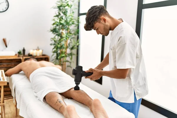 Two Hispanic Men Physiotherapist Patient Massaging Legs Using Percussion Gun — Stock Photo, Image