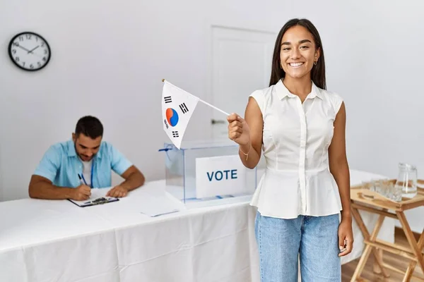 Young south korean voter woman holding south korea flag at electoral college.