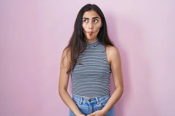 Young Teenager Girl Wearing Casual Striped Shirt Making Fish Face — Stockfoto