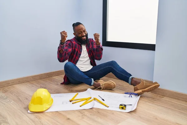 African American Man Sitting Floor New Home Looking Blueprints Very — Stock Photo, Image