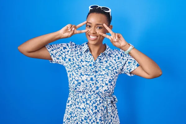African American Woman Standing Blue Background Doing Peace Symbol Fingers —  Fotos de Stock