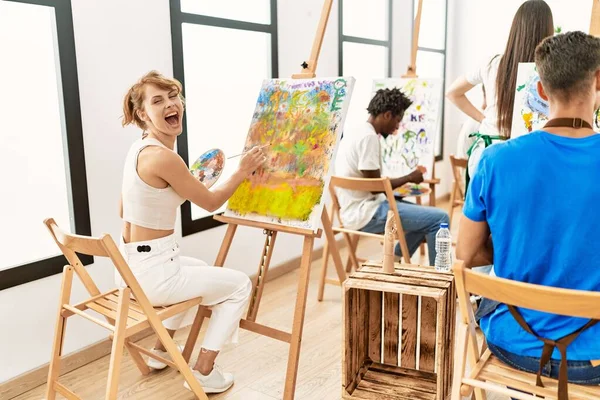Group of people smiling happy drawing at art studio.