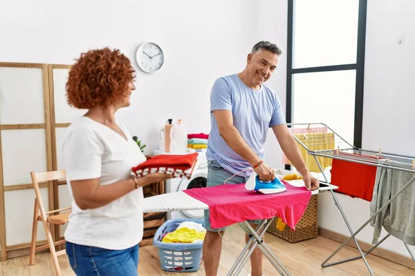 Middle Age Man Woman Couple Smiling Confident Ironing Clothes Laundry — ストック写真