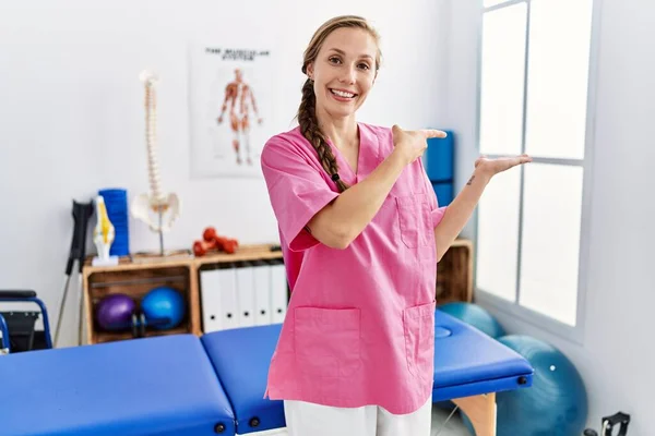 Young Blonde Woman Working Pain Recovery Clinic Amazed Smiling Camera — Stock Photo, Image