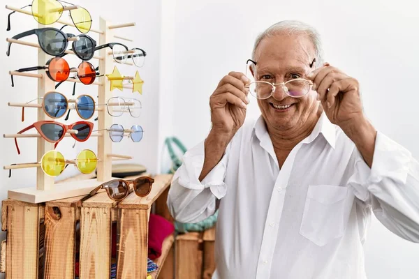 Senior man customer wearing glasses at clothing store