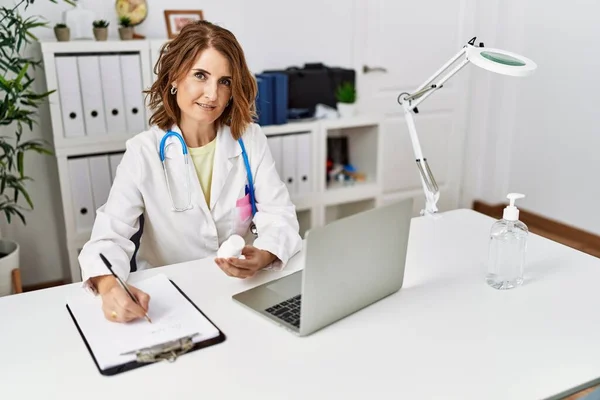 Středního Věku Hispánská Žena Nosí Lékařskou Uniformu Drží Pilulky Klinice — Stock fotografie