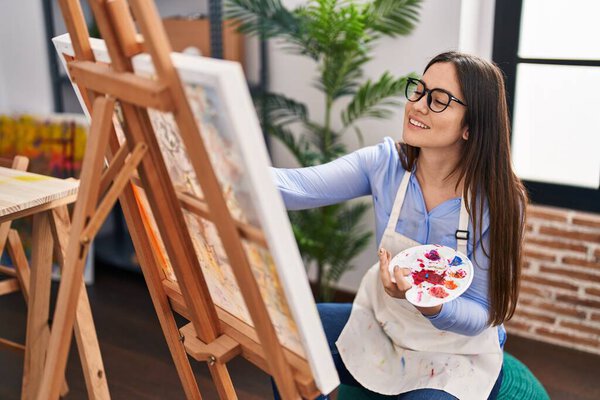 Young woman artist smiling confident drawing at art studio