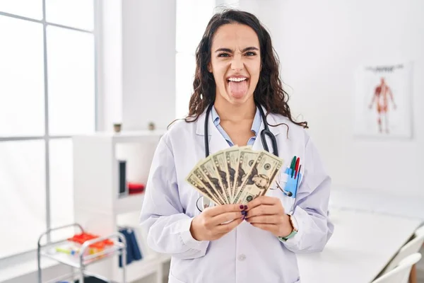 Young Doctor Woman Holding Money Sticking Tongue Out Happy Funny — Foto de Stock