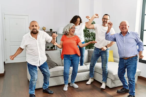 Group of middle age friends having party dancing at home.