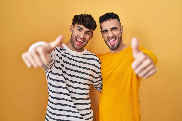 Young Hispanic Gay Couple Standing Yellow Background Approving Doing Positive — Stock Photo, Image