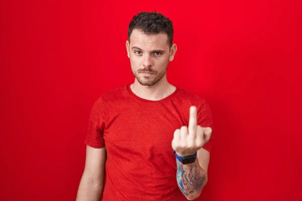 Young Hispanic Man Standing Red Background Showing Middle Finger Impolite —  Fotos de Stock