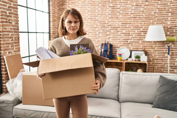 Young Beautiful Woman Holding Box Moving New Home Skeptic Nervous — Foto de Stock