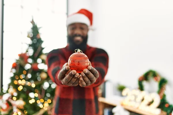 Young African American Man Smiling Confident Holding Ball Standing Christmas — стокове фото