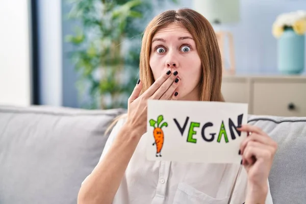 Beautiful Woman Holding Banner Vegan Word Covering Mouth Hand Shocked — Stock Photo, Image