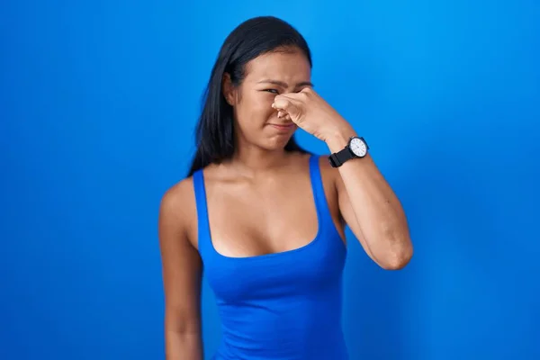 Mujer Hispana Pie Sobre Fondo Azul Oliendo Algo Apestoso Asqueroso —  Fotos de Stock