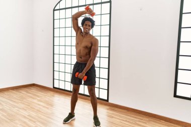 Spor salonunda dambıllar kullanarak genç Afro-Amerikan erkek eğitimi