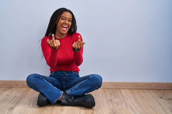 Young African American Braids Sitting Floor Home Showing Middle Finger — Stockfoto